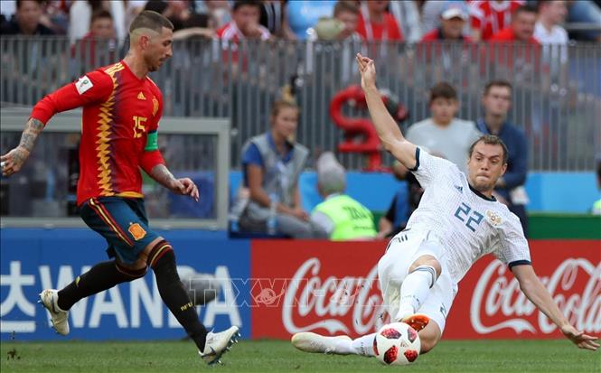 Trong ảnh: Cầu thủ Sergio Ramos (trái) của Tây Ban Nha trong pha tranh bóng với tuyển thủ Nga Artem Dzyuba trong trận đấu vòng 1/8 World Cup 2018 diễn ra trên sân Luzhniki ở Moskva ngày 1/7. Ảnh: THX/TTXVN