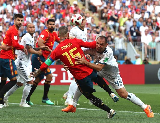 Trong ảnh: Hậu vệ Sergio Ramos (số 15)của Tây Ban Nha ăn mừng bàn thắng phản lưới nhà mở tỷ số của cầu thủ Nga Sergey Ignashevich (phải, phía dưới) tại vòng 1/8 FIFA World Cup 2018 trên sân Luzhniki ở Moskva ngày 1/7. Ảnh: THX/TTXVN