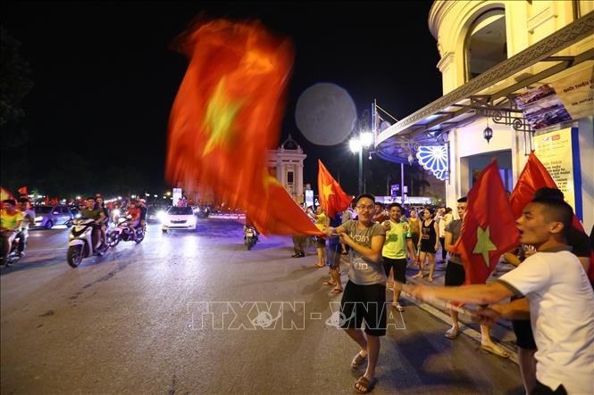 Trong ảnh: Người dân Hà Nội xuống đường cổ vũ Olympic Việt Nam sau chiến thắng trước đội tuyển Olympic Syria. Ảnh: Bùi Cương Quyết - TTXVN