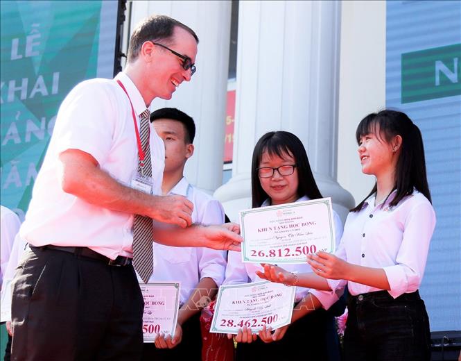 Trong ảnh: Ông Sean Watts, Phó Hiệu trưởng Đại học Đông Á trao bảng tượng trưng tặng số tiền học bổng cho các tân sinh viên. Ảnh: Phương Chi – TTXVN phát