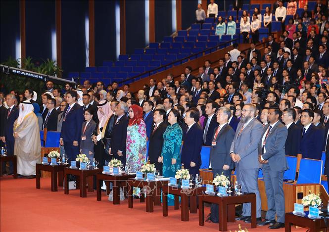 Photo: Delegates during the flag-saluting ceremony. VNA Photo