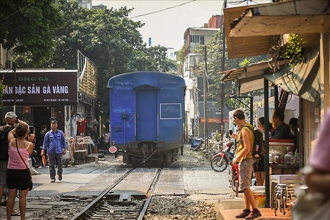 Trong ảnh: Đoàn tàu chạy qua để lại phía sau những gương mặt dõi theo cho đến khi khuất hẳn. Ảnh: Trọng Đạt - TTXVN