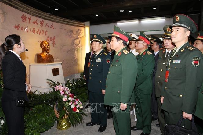 Photo: Defence Minister Ngo Xuan Lich and Chinese Defence Minister Wei Fenghe visit a memorial house dedicated to President Ho Chi Minh in Long Zhou. VNA Photo: Dương Giang