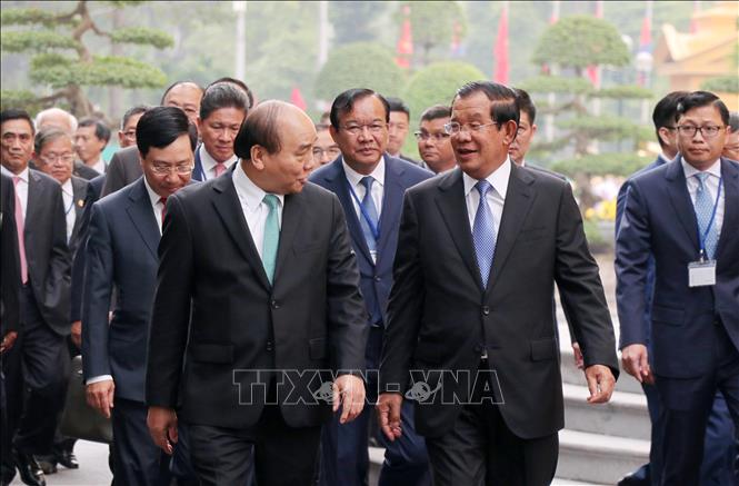 Trong ảnh: Thủ tướng Nguyễn Xuân Phúc trao đổi thân mật với Thủ tướng Campuchia Samdech Techo Hun Sen trên đường đến Trụ sở Chính phủ để hội đàm. Ảnh: Văn Điệp – TTXVN