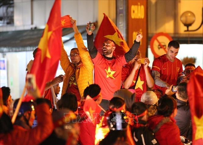 Photo: Vietnamese fans celebrate the team’s victory. VNA Photo