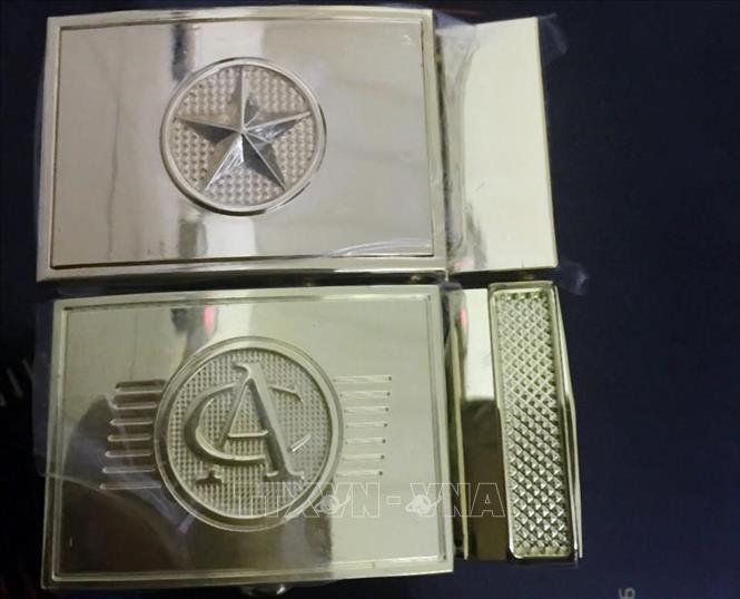 Trong ảnh: Khóa dây lưng giả nhãn hiệu của Công an và Quân đội bị thu giữ. Ảnh: Trần Việt - TTXVN