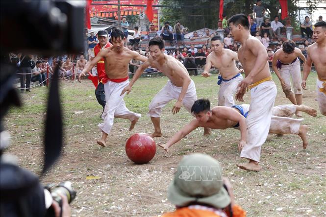 Trong ảnh: Một pha cố gắng bay cả người nhoài theo để đẩy cầu về hố của đội mình tại Lễ hội vật cầu truyền thống đình Thúy Lĩnh. Ảnh: Anh Tuấn - TTXVN