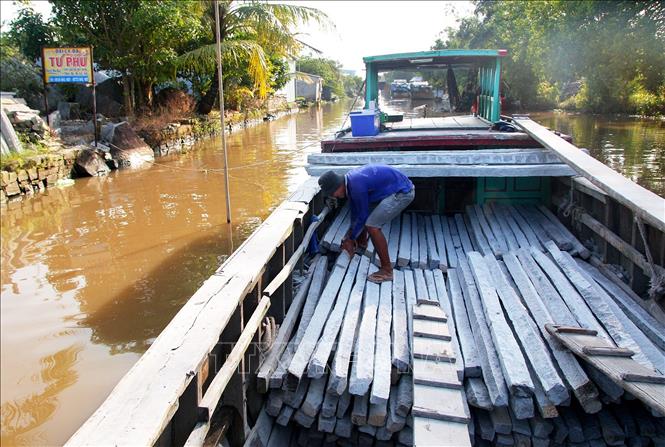 Trong ảnh: Xếp đá lên ghe để vận chuyển đá ra thị trường. Ảnh: Hồng Đạt - TTXVN

