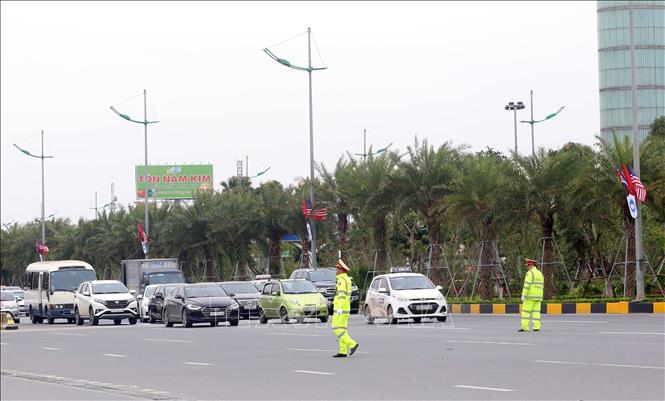 Photo: Policemen halt the traffic to give way for the DPRK mission's vehicles to Hanoi on February 24. VNA Photo: Huy Hung