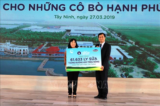 Trong ảnh: Đại diện Vinamilk tặng 61.633 ly sữa (tương đương 400 triệu đồng) cho trẻ em tỉnh Tây Ninh. Ảnh: Lê Đức Hoảnh-TTXVN