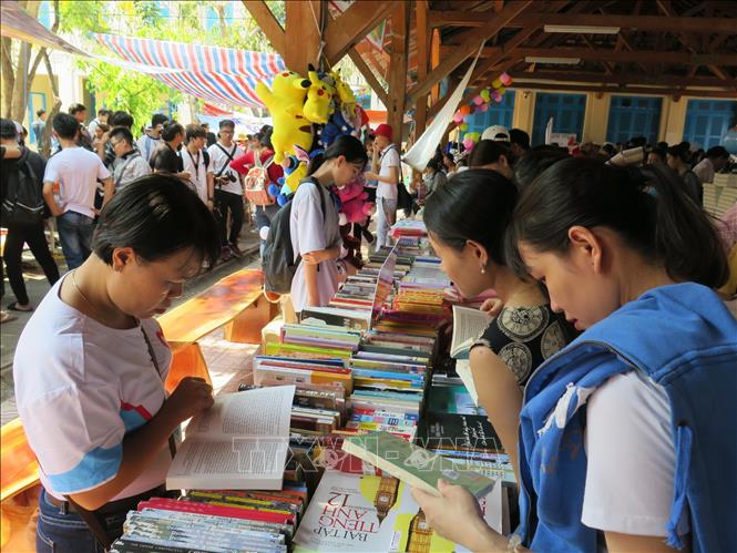 Trong ảnh: Các bạn trẻ tìm hiểu kiến thức về Đoàn Thanh niên Cộng sản Hồ Chí Minh tại gian trưng bày sách của Tỉnh đoàn Khánh Hòa. Ảnh: Phan Sáu - TTXVN