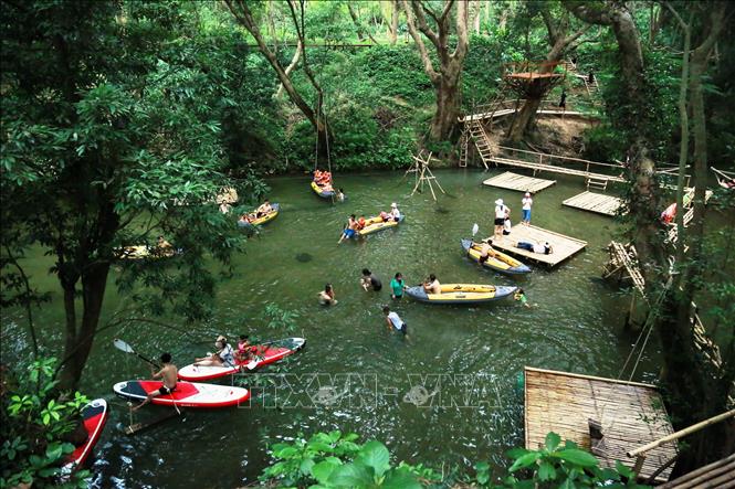 Photo: A range of activies can be found at Ozo Treetop Park: swimming, kayaking, walking on bamboo bridges or trying adventure sports. VNA Photo: Mạnh Thành