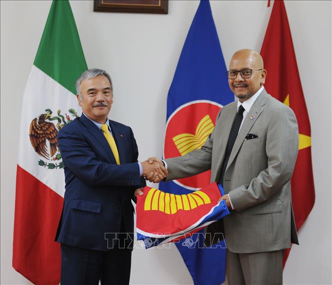Đại sứ Việt Nam Nguyễn Hoài Dương trao cờ ASEAN cho Đại sứ Indonesia Cosmas Cheppy Tri Prakoso Wartono. Ảnh: Việt Hùng-Pv TTXVN tại Mexico
