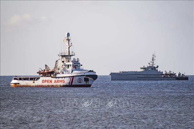 Trong ảnh: Tàu nhân đạo Open Arms (trái) chở người di cư được giải cứu ở ngoài khơi đảo Lampedusa, miền Nam Italy ngày 15/8/2019. Ảnh: AFP/TTXVN