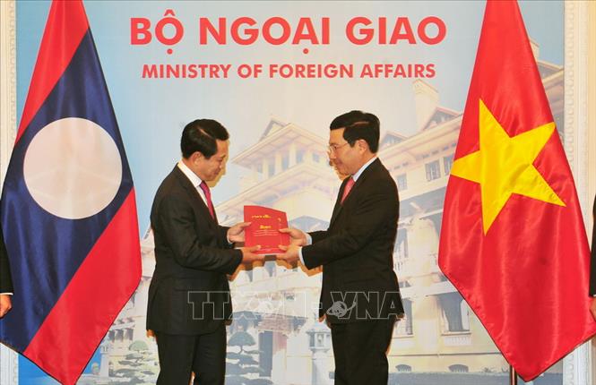 Trong ảnh: Phó Thủ tướng, Bộ trưởng Ngoại giao Phạm Bình Minh và Bộ trưởng Ngoại giao Lào Saleumxay Kommasith trao đổi tượng trưng hai ấn phẩm văn kiện pháp lý biên giới Việt Nam - Lào, nhân dịp Tham vấn thường niên cấp Bộ trưởng Ngoại giao lần thứ tư, ngày 6/12/2017 tại Hà Nội. Ảnh: Nguyễn Khang – TTXVN
 