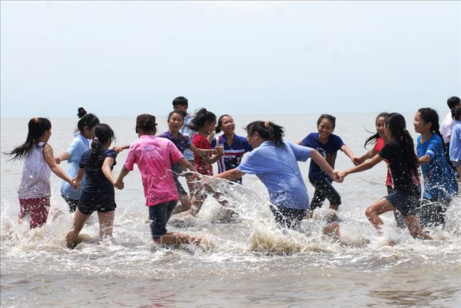 Trong ảnh: Các trại sinh 3 nước Việt Nam – Lào – Campuchia tham gia trò chơi ngoài biển Cần Giờ tại Trại hè Hữu nghị giao lưu thiếu nhi quốc tế - TP Hồ Chí Minh năm 2012 với chủ đề “Vòng tay bè bạn” (24 – 28/7/2012). Ảnh: Mạnh Linh - TTXVN