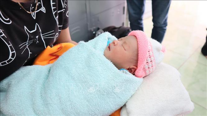 Trong ảnh: Bé sơ sinh bị bỏ rơi trước cổng chùa đang được chăm sóc tại trạm y tế xã Nghĩa Trung. Ảnh: Đậu Tất Thành - TTXVN