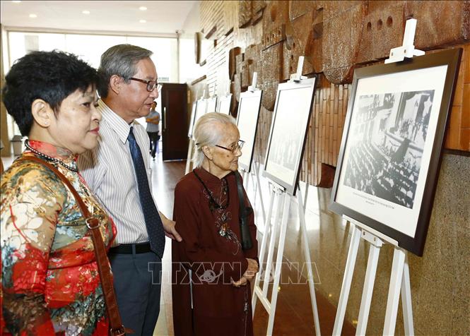 Trong ảnh: Con gái của nguyên Trưởng ban Thường trực Quốc hội Bùi Bằng Đoàn (người đứng hàng đầu bên phải) tham quan trưng bày ảnh tại Lễ kỷ niệm. Ảnh: Văn Điệp – TTXVN 