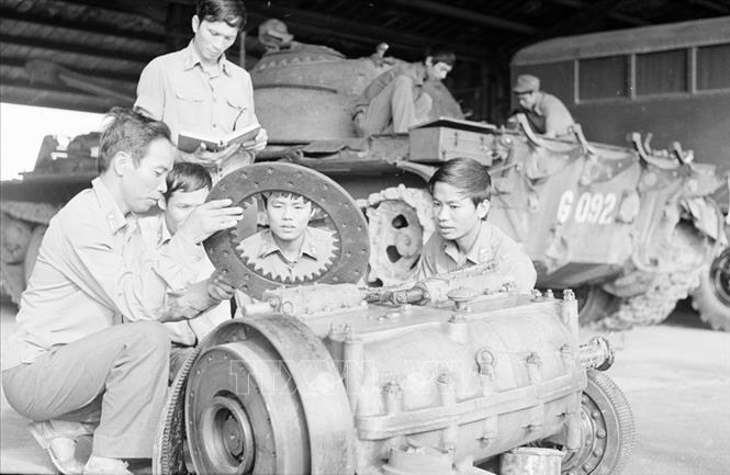 Trong ảnh: Trung tá Nguyễn Hữu Tưởng, Phó Sư đoàn trưởng Sư đoàn 304 hướng dẫn các kỹ sư kỹ thuật sửa chữa máy xe tăng của Lữ đoàn 203. Ảnh: Kim Hùng - TTXVN