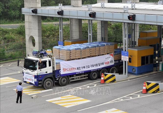 Trong ảnh: (tư liệu) Xe tải chở bột mì viện trợ cho CHDCND Triều Tiên qua cửa khẩu Paju, phía bắc Seoul, Hàn Quốc. Ảnh: AFP/TTXVN