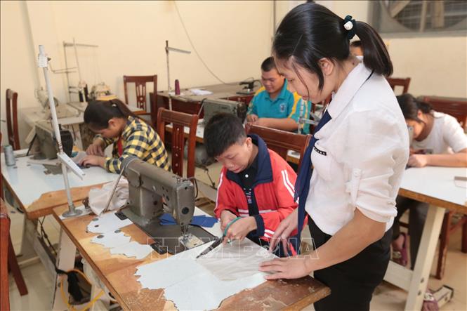 Trong ảnh: Lớp dạy nghề Cắt may cho các học sinh khuyết tật tại Trường Phục hồi chức năng và dạy nghề cho người khuyết tật Tiên Lữ. Ảnh: Anh Tuấn – TTXVN