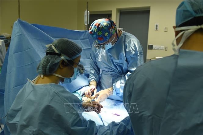 Photo: Dr Stéphane Guero conducts a hand surgery.