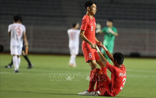 Trong ảnh: Nỗi buồn của các cầu thủ Singapore. Ảnh: Hoàng Linh- TTXVN
