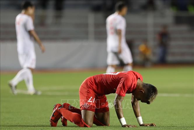 Trong ảnh: Nỗi buồn của các cầu thủ Singapore. Ảnh: Hoàng Linh- TTXVN