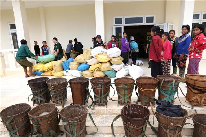 25. Trong thời bình, cán bộ, chiến sĩ quân đội càng phải thật sự đi sâu, đi sát, gần gũi nhân dân. Trong ảnh: Bộ đội Đồn biên phòng A Xan (huyện miền núi Tây Giang, tỉnh Quảng Nam) phát gạo cứu đói cho nhân dân vùng biên giới. Ảnh: Anh Tuấn – TTXVN