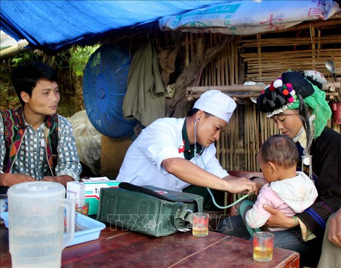 Bác sĩ của Bệnh xá quân y - Đoàn kinh tế quốc phòng 365 xuống bản khám, điều trị cho bệnh nhi của xã Pa Vây Sử, huyện Phong Thổ, tỉnh Lai Châu. Ảnh: Quý Trung - TTXVN
