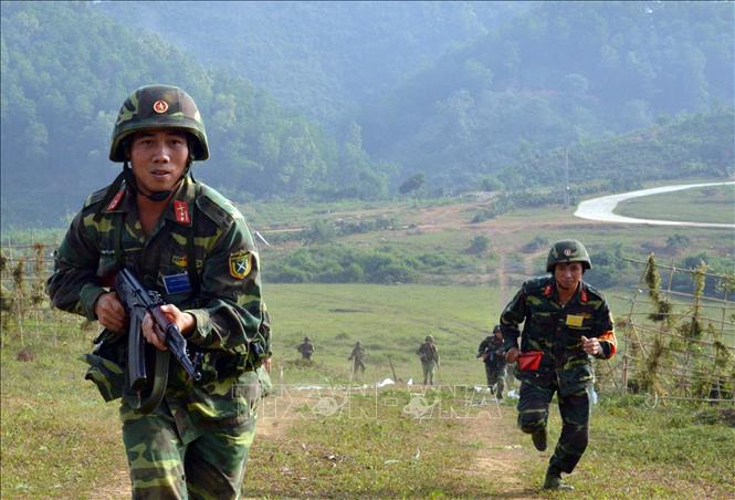 Xây dựng phòng thủ quân khu, khu vực phòng thủ vững chắc toàn diện, hợp thành phòng thủ đất nước; củng cố, tăng cường tiềm lực quốc phòng vùng chiến lược, trọng điểm, biển, đảo, khu vực biên giới, địa bàn xung yếu. Trong ảnh: Lực lượng bộ binh Tiểu đoàn 5, Sư đoàn bộ binh 316 (Quân khu 2) vượt cửa mở đánh chiếm đầu cầu trong cuộc diễn tập chiến thuật có bắn đạn thật một bên hai cấp có hiệp đồng với các lực lượng vũ trang địa phương, dân quân tự vệ, thiết giáp, thông tin... năm 2015. Ảnh: Trọng Đức – TTXVN