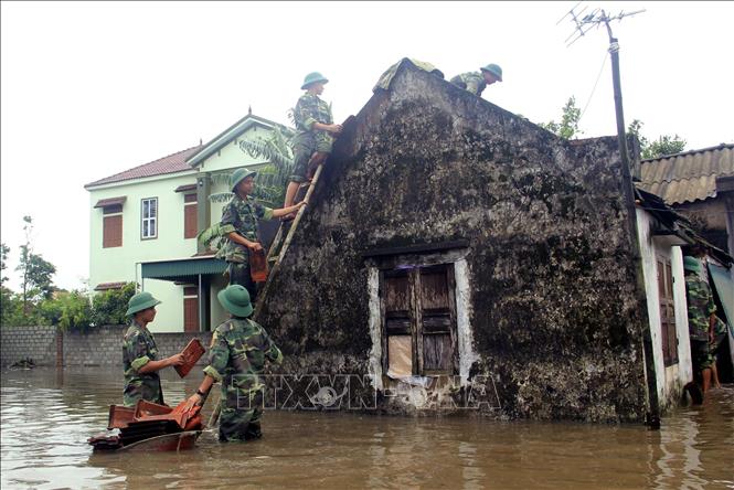 Bộ đội luôn kề vai sát cánh cùng nhân dân khắc phục hậu quả thiên tai, lũ lụt. Trong ảnh: Cán bộ, chiến sỹ bộ đội địa phương tỉnh Hà Tĩnh giúp nhân dân huyện Nghi Xuân khắc phục hậu quả do mưa lũ gây ra. Ảnh: TTXVN