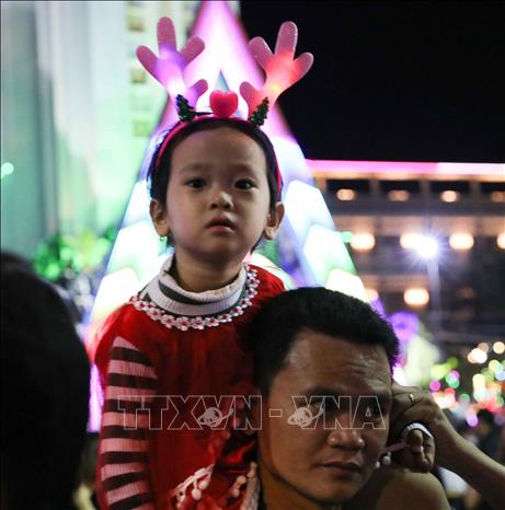 Trong ảnh: Các em nhỏ được bố mẹ đưa tới Nhà thờ Chính tòa Quy Nhơn để đón Giáng sinh. Ảnh: Thanh Tùng-TTXVN