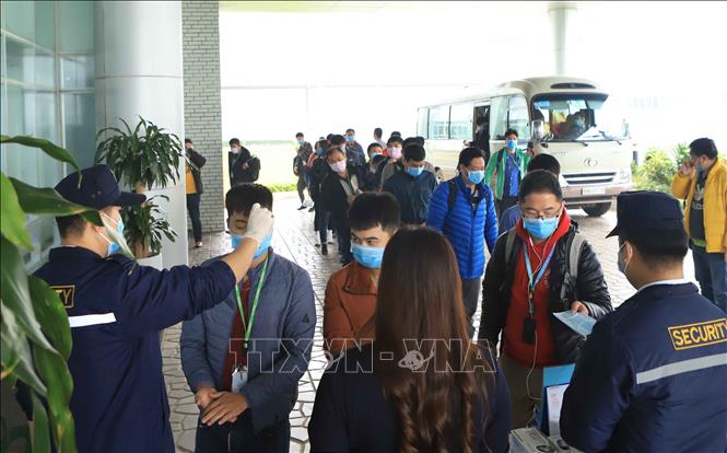 Trong ảnh: Tất cả công nhân, cán bộ, khách hàng đến làm việc tại Công ty TNHH Compal Việt Nam trong khu công nghiệp Bá Thiện 1 (huyện Bình Xuyên) đều được đo nhiệt độ để phòng chống dịch COVID-19. Ảnh: Hoàng Hùng - TTXVN
