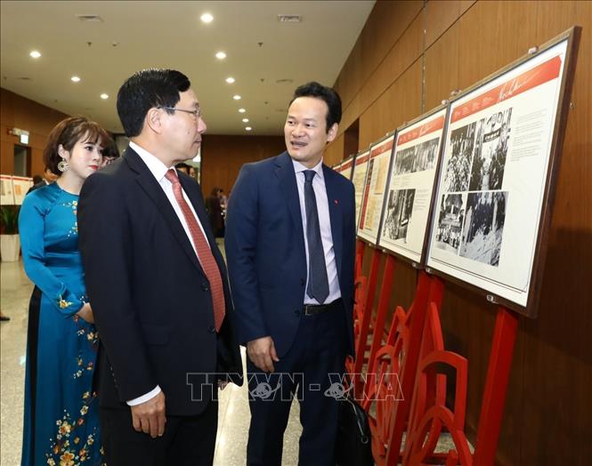 Trong ảnh: Phó Thủ tướng, Bộ trưởng Bộ Ngoại giao Phạm Bình Minh cùng các đại biểu tham quan Triển lãm ảnh 