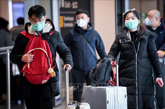 Trong ảnh: Hành khách đeo khẩu trang đề phòng lây nhiễm COVID-19 tại sân bay Charles De Gaulle ở Roissy-en-France, Pháp ngày 26/1/2020. Ảnh: AFP/TTXVN