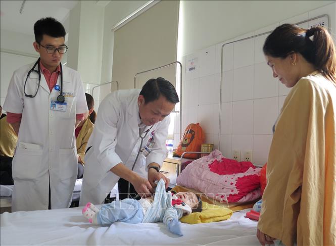 Phó Giáo sư, Tiến sĩ Bùi Bỉnh Bảo Sơn thăm khám bệnh nhi. Ảnh: Mai Trang - TTXVN