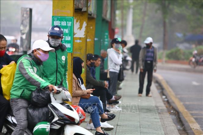 Photo: People in Hanoi's Long Bien bus station wear facial masks as required. VNA Photo: Minh Quyết