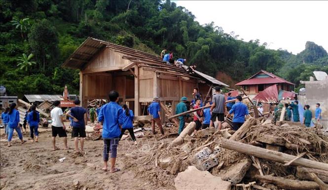 Trong ảnh: Đoàn viên thanh niên huyện Quan Sơn, Thanh Hóa phối hợp với lực lượng vũ trang giúp bà con bản Sa Ná, xã Na Mèo dựng lại nhà cửa sau lũ. Ảnh: TTXVN phát