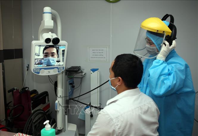 Trong ảnh: Sử dụng thiết bị khám từ xa cho các bệnh nhân có triệu chứng viêm đường hô hấp, người có yếu tố dịch tễ. Ảnh: Danh Lam – TTXVN