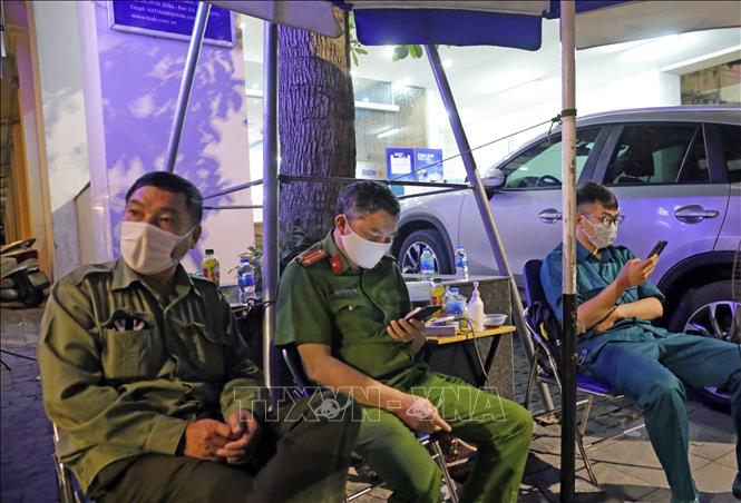 Trong ảnh: Lực lượng chức năng túc trực tại Chi nhánh BIDV Hà Thành. (ảnh chụp tối 26/3). Ảnh: Trần Việt - TTXVN