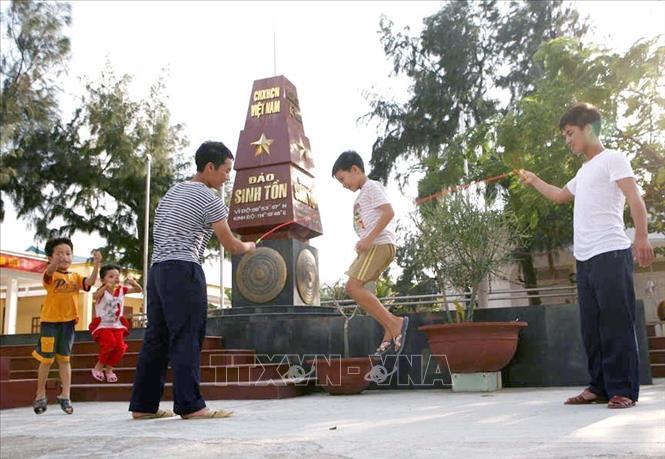 Trong ảnh: Thiếu nhi trên xã đảo Sinh Tồn vui chơi cùng những người lính đảo. Ảnh: Xuân Trường - TTXVN