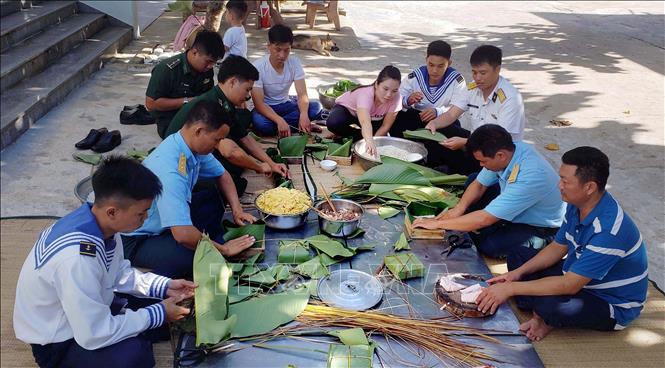 Trong ảnh: Người dân và cán bộ, chiến sĩ thị trấn Trường Sa quây quần gói bánh chưng, chuẩn bị đón Tết Nguyên đán. Ảnh: Hoàng Hùng - TTXVN