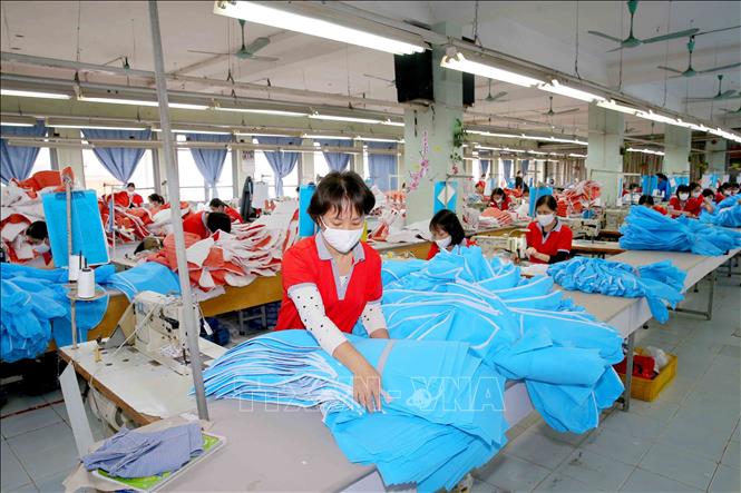 Photo: Producing medical suits and face masks at the Chien Thang Garment JSC in Hanoi. VNA Photo: Phương Hoa