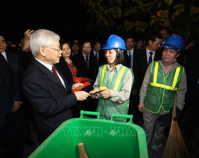 Trong ảnh: Tổng Bí thư, Chủ tịch nước Nguyễn Phú Trọng thăm hỏi, tặng quà công nhân môi trường đang làm việc đêm giao thừa Tết Nguyên đán Kỷ Hợi 2019 tại khu vực Hồ Hoàn Kiếm. Ảnh : Trí Dũng – TTXVN