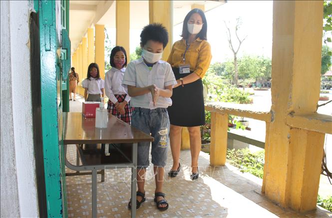 Trong ảnh: Học sinh trường Tiểu học Ninh Khánh, thành phố Ninh Bình sát khuẩn tay trước khi vào lớp. Ảnh: Thùy Dung-TTXVN