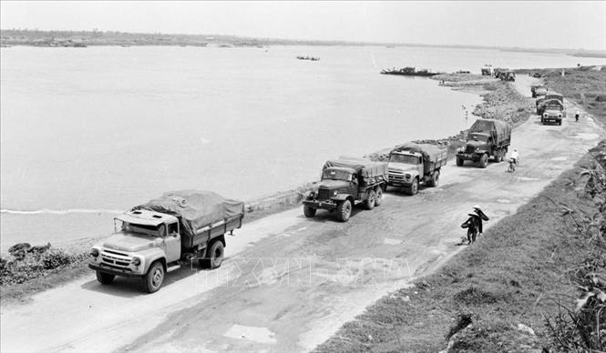 Trong ảnh: Đoàn xe qua bến phà X trên đường vào Trường Sơn. Từ năm 1965 đến 1972, đường Trường Sơn phát triển mạnh mẽ, tiến lên cơ giới hóa toàn tuyến vận tải quân sự. Ảnh: TTXVN