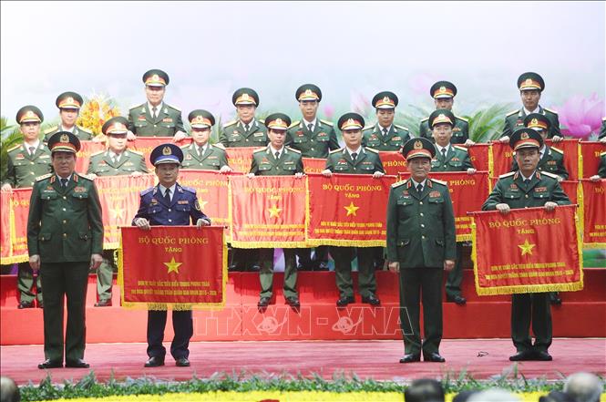 Trong ảnh: Đại tướng Ngô Xuân Lịch, Bộ trưởng Bộ Quốc phòng và Đại tướng Lương Cường, Chủ nhiệm Tổng cục Chính trị QĐND Việt Nam trao Cờ thi đua của Bộ Quốc phòng cho các cá nhân, tập thể có thành tích xuất sắc trong phong trào thi đua quyết thắng toàn quân gia đoạn 2015-2020. Ảnh: Dương Giang – TTXVN
