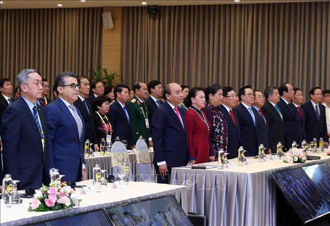 Photo: Delegates during the flag salute ritual at the summit’s opening ceremony. VNA Photo