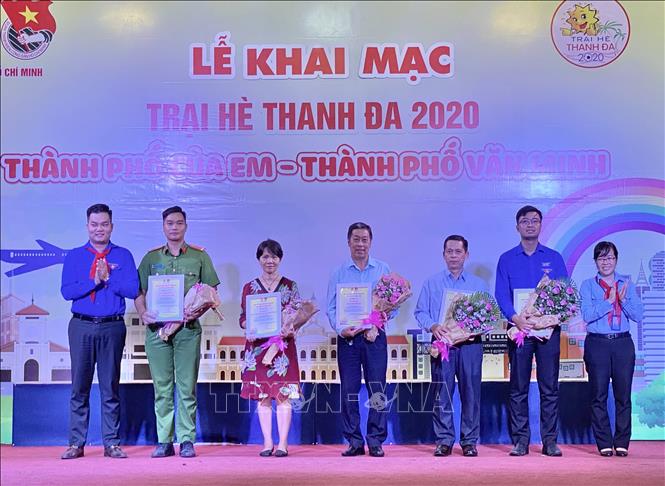 Trong ảnh: Đại diện Ban tổ chức tặng hoa tri ân các đơn vị đồng hành cùng Trại hè năm nay. Ảnh: Hồng Giang - TTXVN.